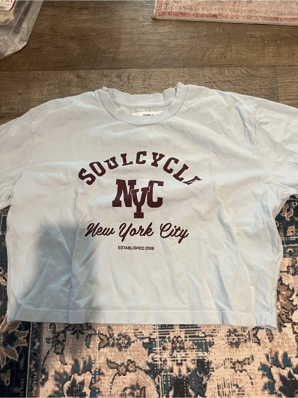 soulcycle light blue tee with maroon NYC logo